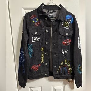 Black, jean jacket with designs.